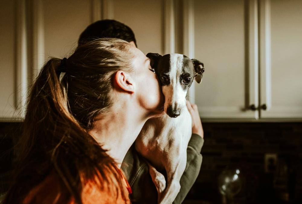 A pet owner sharing a quiet moment with her dog